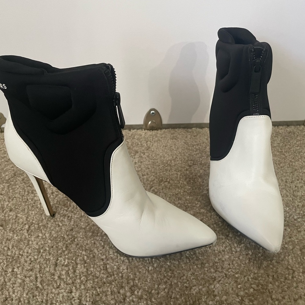 Michael Kors booties. Black and white with zip by front foot.